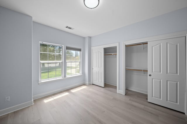 2120 Tradition Way, Redding, CA 96001 - unfurnished bedroom featuring two closets and light wood finished floors