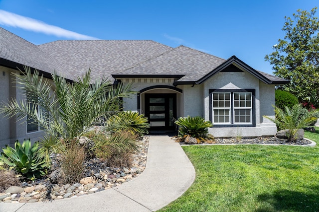 2120 Tradition Way, Redding, CA 96001 - view of front of house featuring a front lawn, roof with shingles, and stucco siding