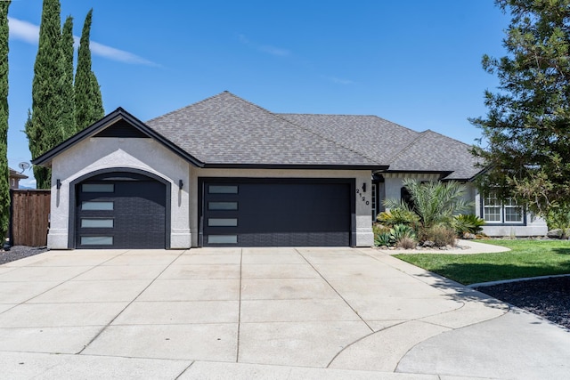 2120 Tradition Way, Redding, CA 96001 - view of front facade featuring an attached garage, driveway, stucco siding, and roof with shingles