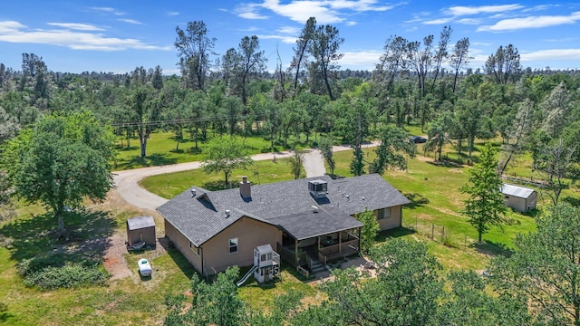drone / aerial view featuring a wooded view