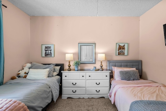 bedroom featuring a textured ceiling and carpet flooring