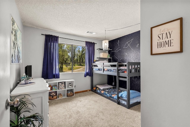 carpeted bedroom featuring visible vents and a textured ceiling