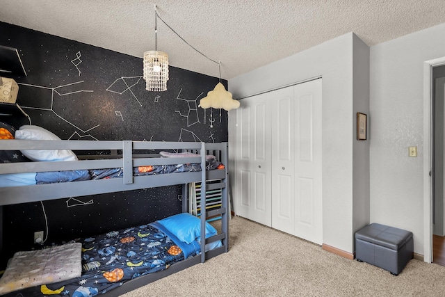 bedroom featuring carpet, a textured ceiling, and a closet