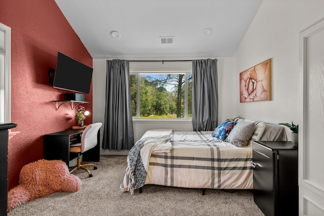 carpeted bedroom featuring visible vents and vaulted ceiling