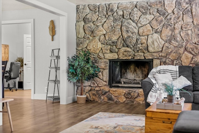 living room with wood finished floors and a fireplace