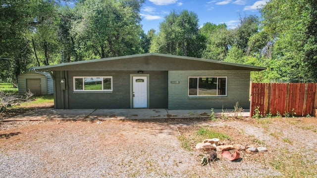 1331 Harpole Rd Unit A, Redding, CA 96002 - view of front facade with fence, a storage unit, and an outbuilding