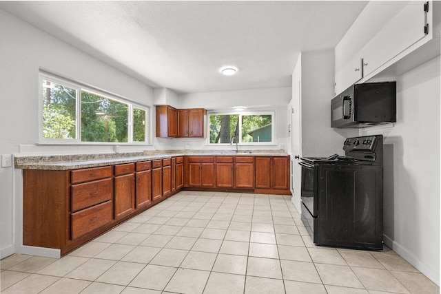1331 Harpole Rd Unit A, Redding, CA 96002 - kitchen with brown cabinets, light countertops, a sink, baseboards, and black appliances