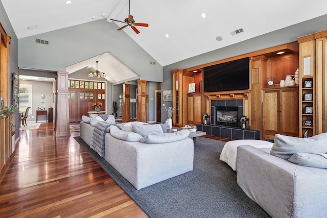 15320 Middletown Park Dr, Redding, CA 96001 - living area featuring high vaulted ceiling, a tile fireplace, wood finished floors, ceiling fan, and a chandelier