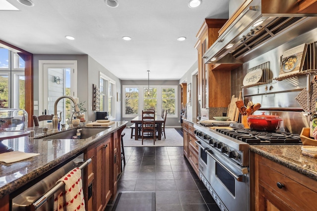 15320 Middletown Park Dr, Redding, CA 96001 - kitchen with stainless steel appliances, wall chimney exhaust hood, brown cabinetry, recessed lighting, and tasteful backsplash