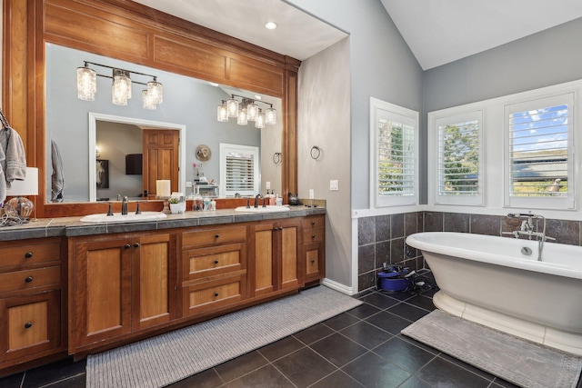 15320 Middletown Park Dr, Redding, CA 96001 - full bath featuring tile patterned floors, vaulted ceiling, double vanity, and a soaking tub
