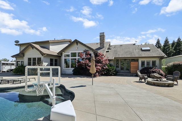 15320 Middletown Park Dr, Redding, CA 96001 - rear view of house with french doors, a fire pit, a patio area, a tile roof, and a chimney