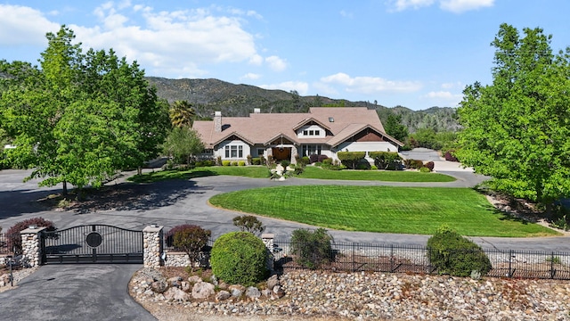 15320 Middletown Park Dr, Redding, CA 96001 - view of front of house featuring a mountain view, curved driveway, a gate, and a chimney