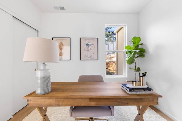 office featuring wood finished floors, visible vents, and baseboards