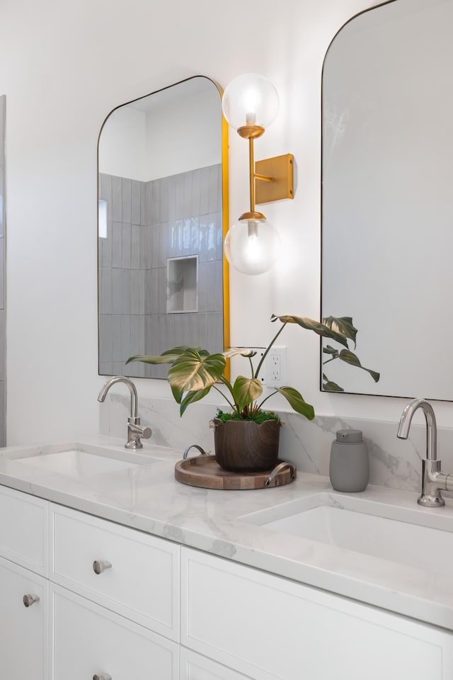 bathroom featuring a sink and double vanity