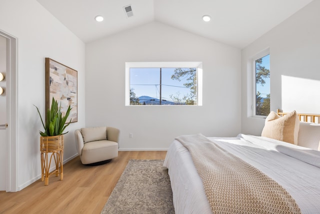 bedroom featuring light wood-style floors, baseboards, lofted ceiling, visible vents, and recessed lighting