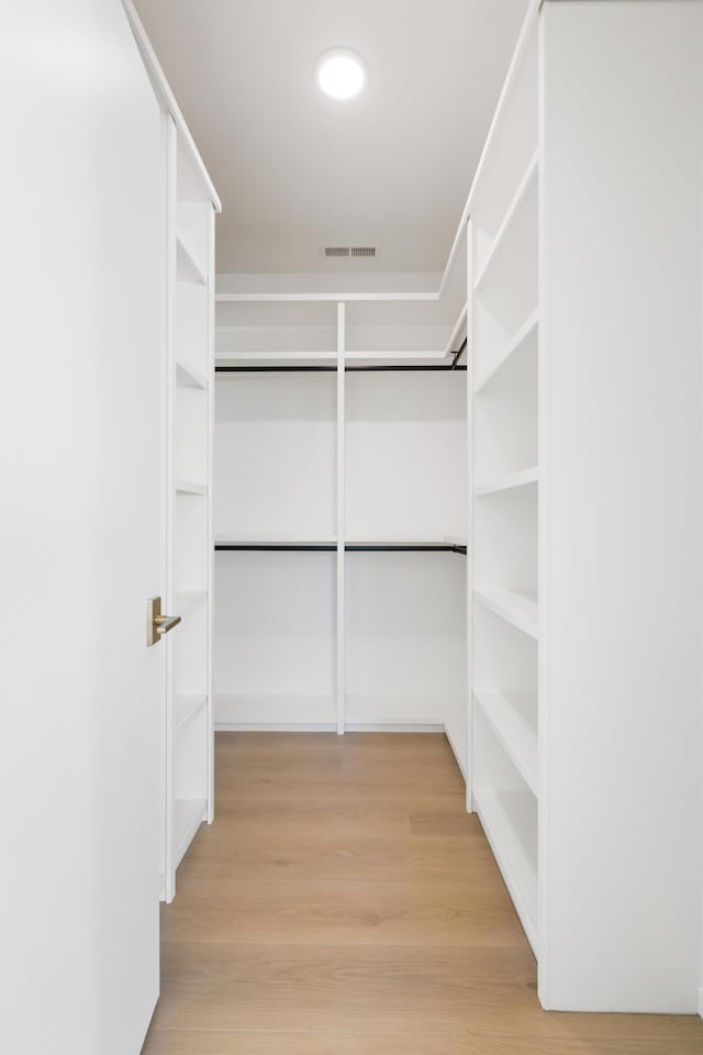walk in closet with visible vents and light wood finished floors
