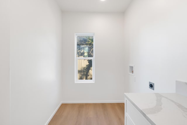 laundry area featuring hookup for an electric dryer, light wood finished floors, baseboards, laundry area, and washer hookup
