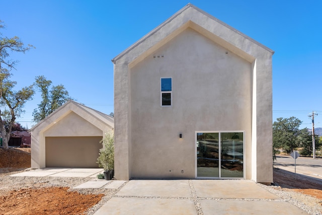 view of front of house with a garage and stucco siding