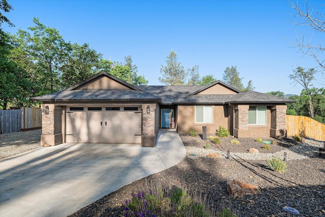 ranch-style house featuring an attached garage, driveway, fence, and stucco siding