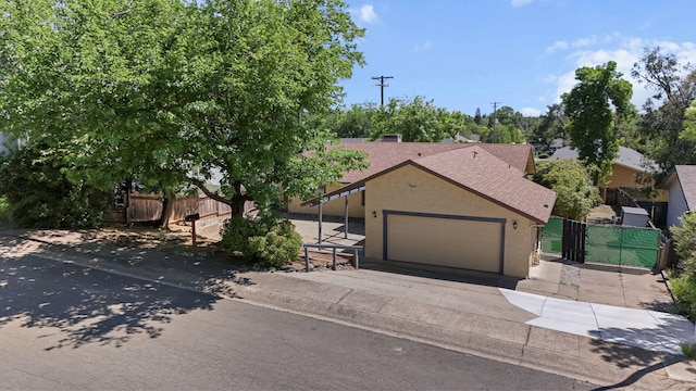 2831 Camulos Way, Redding, CA 96002 - view of front of home with a garage, concrete driveway, fence, and stucco siding