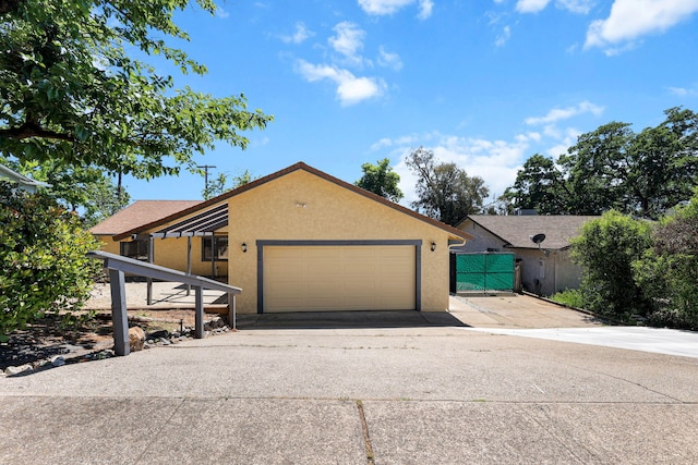 2831 Camulos Way, Redding, CA 96002 - view of front facade featuring concrete driveway, fence, stucco siding, and a garage