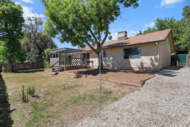 2831 Camulos Way, Redding, CA 96002 - view of front facade with fence, a pergola, a front lawn, stucco siding, and a deck