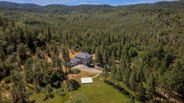 bird's eye view with a wooded view