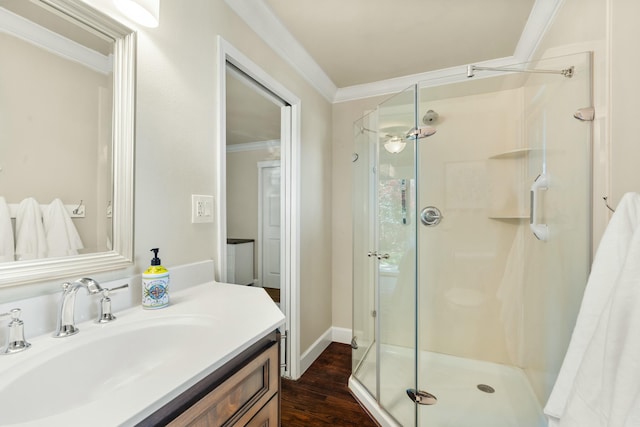 6860 Riata Dr, Redding, CA 96002 - bathroom featuring a stall shower, baseboards, wood finished floors, crown molding, and vanity
