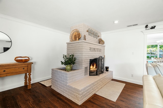 6860 Riata Dr, Redding, CA 96002 - living room featuring visible vents, baseboards, a brick fireplace, and crown molding