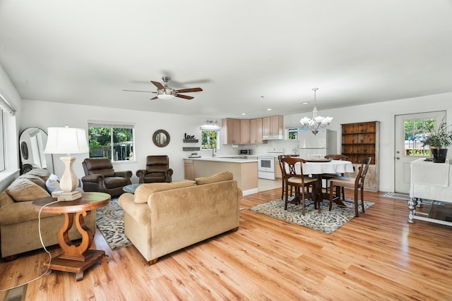 6860 Riata Dr, Redding, CA 96002 - living area with recessed lighting, light wood-style floors, visible vents, and ceiling fan with notable chandelier
