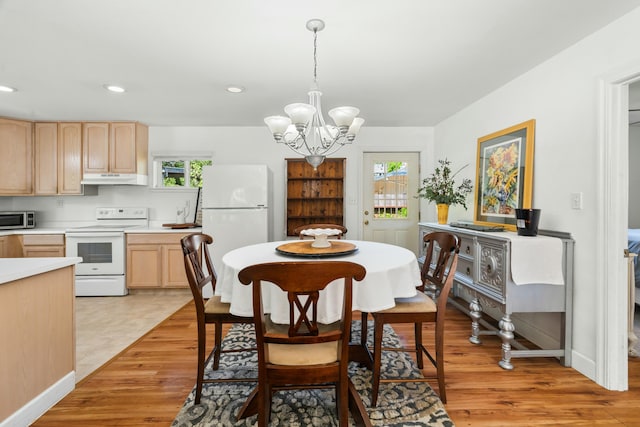 6860 Riata Dr, Redding, CA 96002 - dining space with recessed lighting, light wood-type flooring, baseboards, and an inviting chandelier