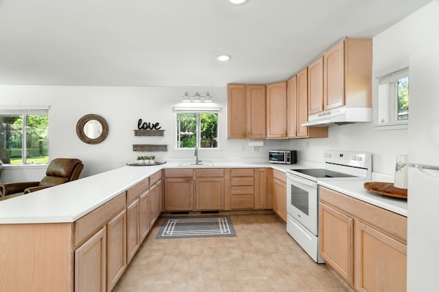 6860 Riata Dr, Redding, CA 96002 - kitchen featuring under cabinet range hood, white range with electric stovetop, light brown cabinets, a sink, and a peninsula