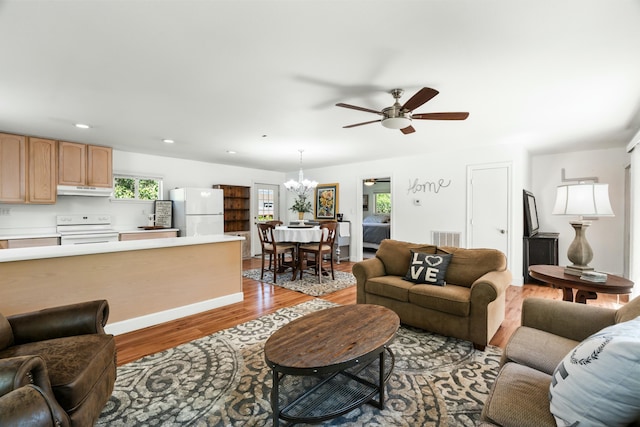 6860 Riata Dr, Redding, CA 96002 - living area with recessed lighting, ceiling fan with notable chandelier, visible vents, and light wood-style flooring