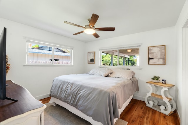 6860 Riata Dr, Redding, CA 96002 - bedroom with wood finished floors, a ceiling fan, and baseboards