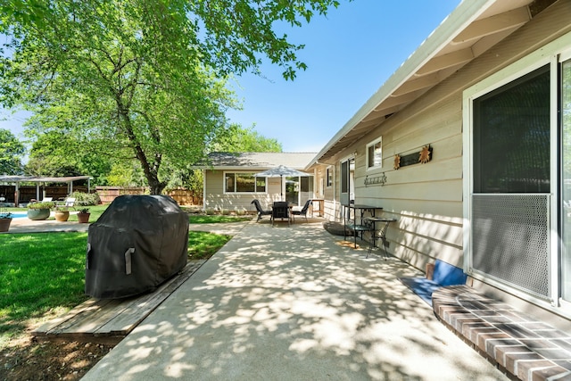 6860 Riata Dr, Redding, CA 96002 - view of patio with fence, a swimming pool, outdoor dining area, and a grill