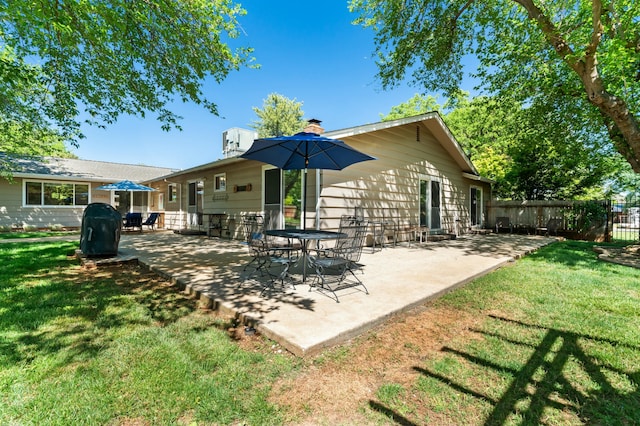 6860 Riata Dr, Redding, CA 96002 - rear view of house with a yard, a chimney, a patio, and fence