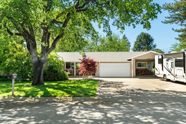 6860 Riata Dr, Redding, CA 96002 - ranch-style home featuring an attached garage, a shingled roof, a front yard, and concrete driveway