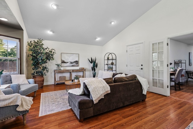 living room with recessed lighting, baseboards, wood finished floors, and high vaulted ceiling