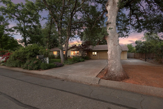 7057 Riata Dr, Redding, CA 96002 - ranch-style house with fence, concrete driveway, and a garage