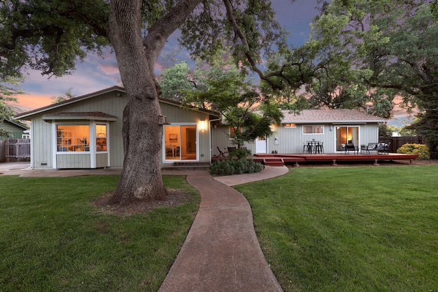7057 Riata Dr, Redding, CA 96002 - back of house at dusk with a deck