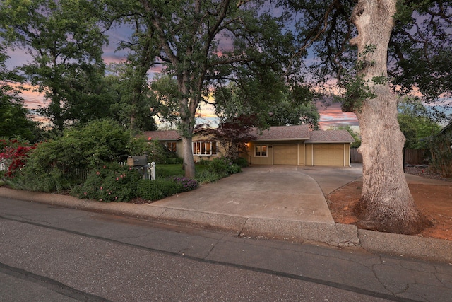 7057 Riata Dr, Redding, CA 96002 - view of front of house featuring a garage, driveway, and fence