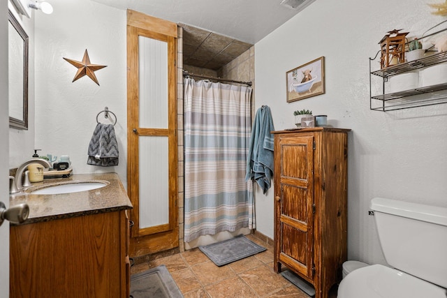 4647 County Road Ff, Orland, CA 95963 - full bathroom featuring toilet, vanity, a shower with curtain, and stone finish flooring