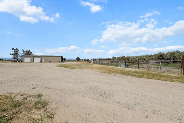 4647 County Road Ff, Orland, CA 95963 - view of yard with a garage, fence, a view of rural / pastoral area, an outbuilding, and dirt driveway