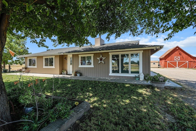 4647 County Road Ff, Orland, CA 95963 - ranch-style house with a barn, a front yard, a chimney, and an outbuilding