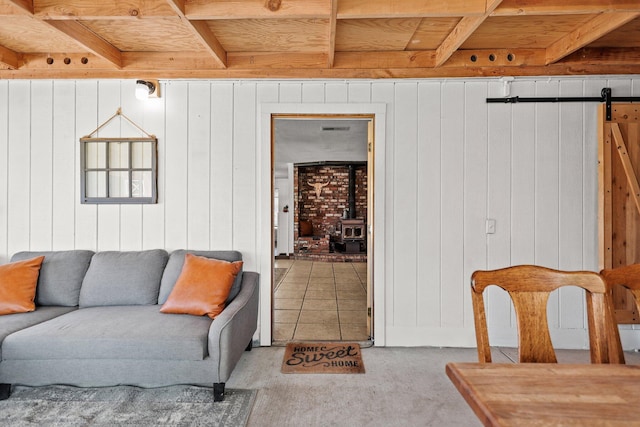 4647 County Road Ff, Orland, CA 95963 - living area featuring a wood stove, carpet flooring, wooden walls, wooden ceiling, and beamed ceiling