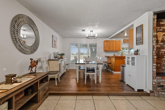 4647 County Road Ff, Orland, CA 95963 - dining room with light tile patterned floors, a chandelier, and a textured ceiling