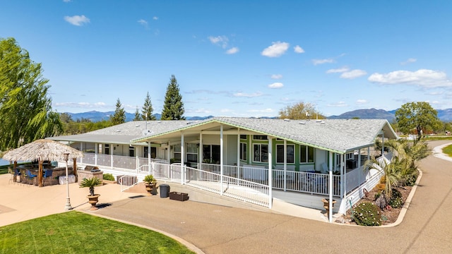 21623 Seven Lakes Ln, Redding, CA 96003 - view of front of home with outdoor dry bar, a patio area, and a mountain view