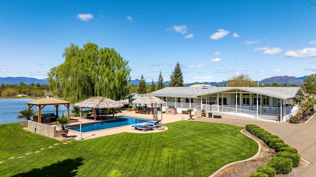 21623 Seven Lakes Ln, Redding, CA 96003 - back of house featuring a lawn, a gazebo, a mountain view, and an outdoor pool