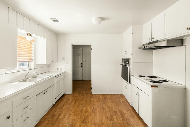 21623 Seven Lakes Ln, Redding, CA 96003 - kitchen with under cabinet range hood, a sink, white appliances, light wood-style floors, and white cabinetry