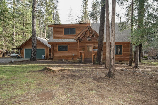cabin with a garage, crawl space, and a shingled roof